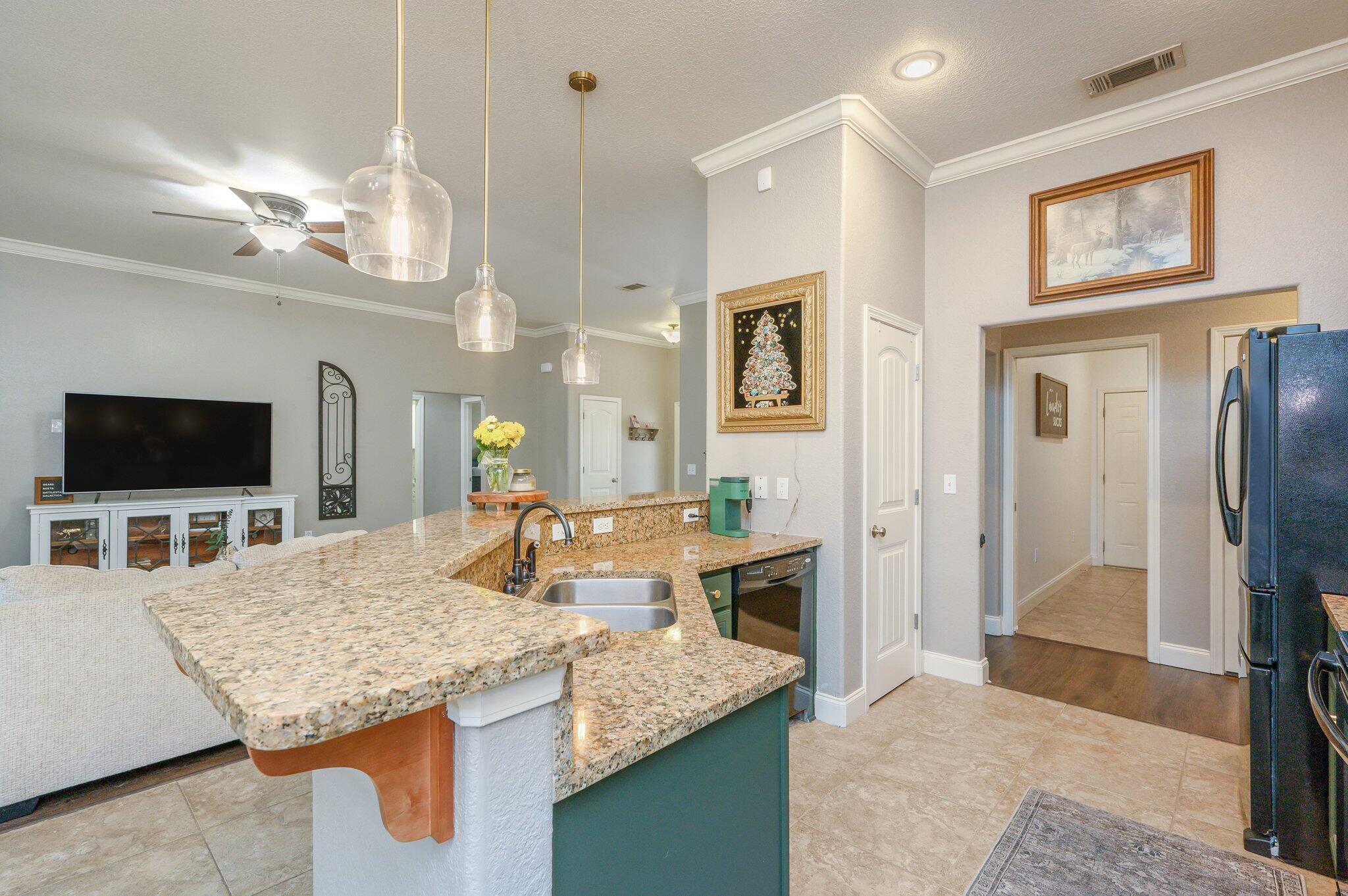 4545 Hermosa Road Crestview, FL 32539 - Photo 10 of 36 a living room with granite countertop furniture and a flat screen tv