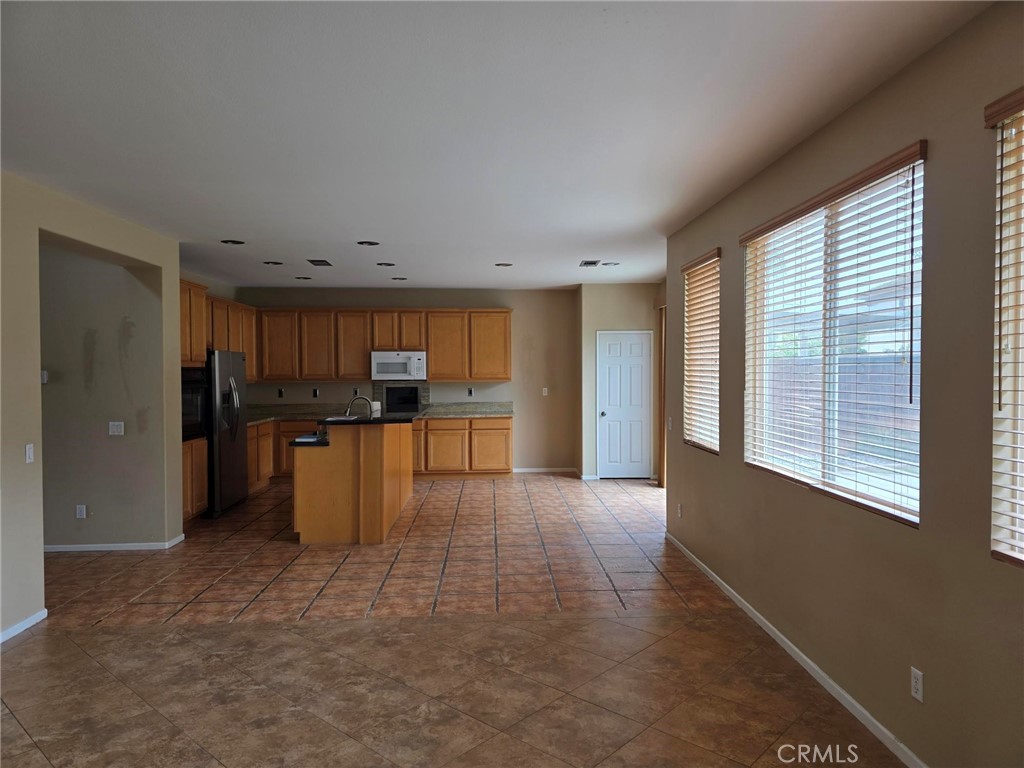 13491 Falcon Ridge Road Eastvale, CA 92880 - Photo 11 of 45 Family room to kitchen