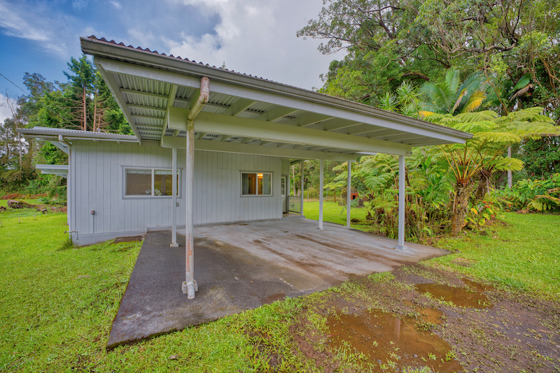 73 Canney Road Mountain View, HI 96771 - Photo 1 of 30 a front view of a house with garden