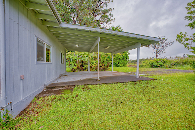 73 Canney Road Mountain View, HI 96771 - Photo 8 of 30 a view of a patio with table and chairs under an umbrella