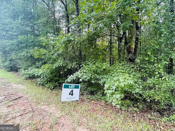 a sign that is sitting in the forest