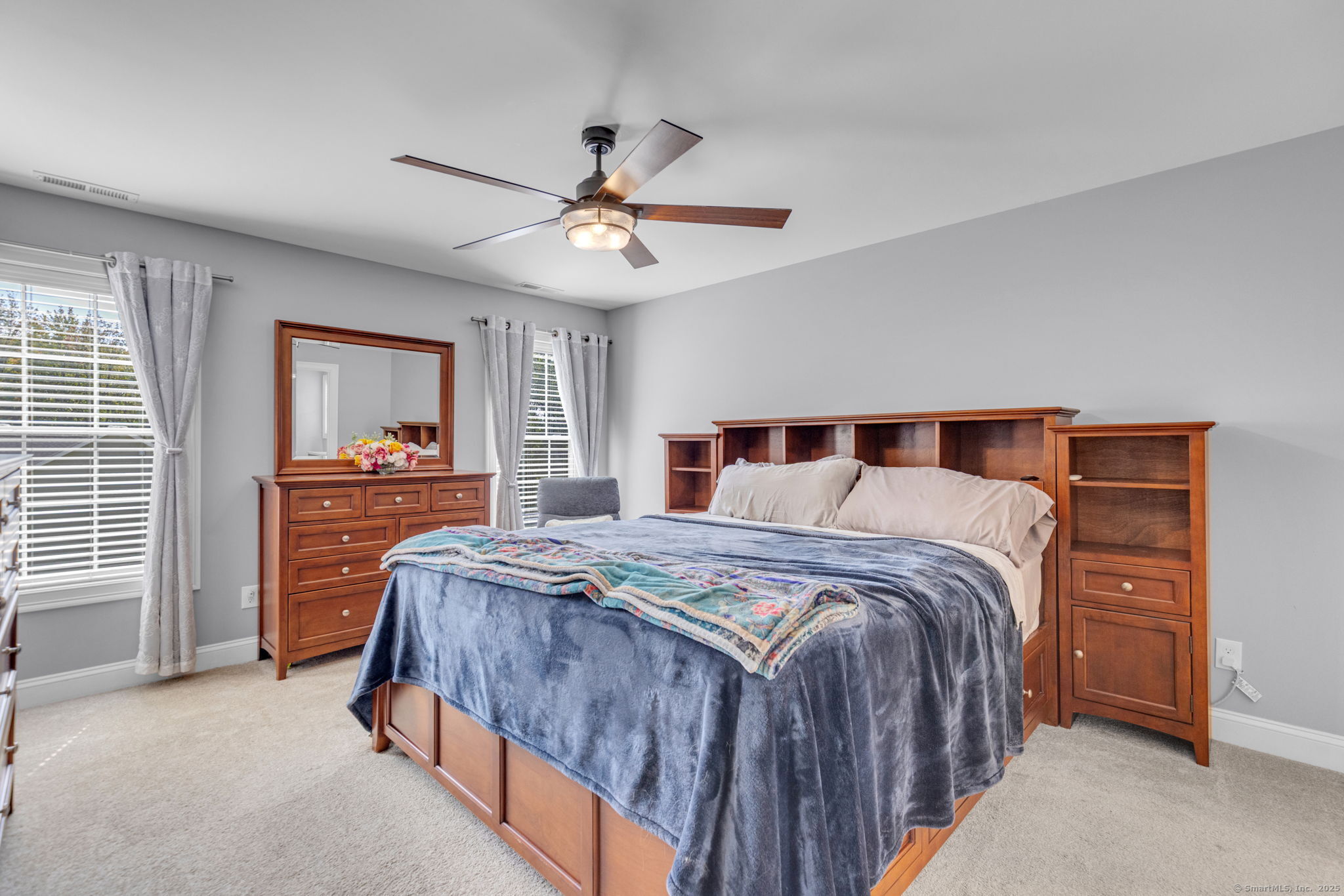 1209 Woodtick Road Wolcott, CT 06716 - Photo 15 of 40 a bedroom with a bed and a chandelier