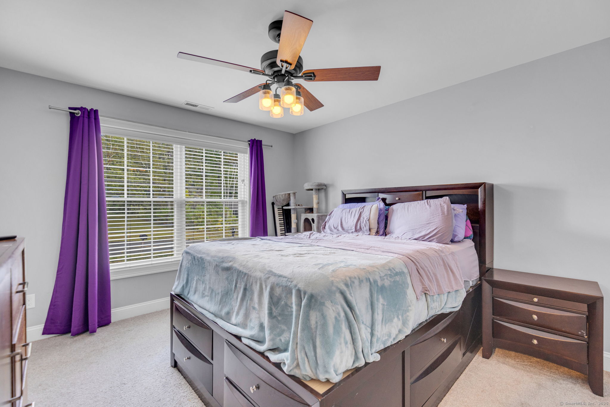 1209 Woodtick Road Wolcott, CT 06716 - Photo 20 of 40 a bedroom with a bed and a chandelier