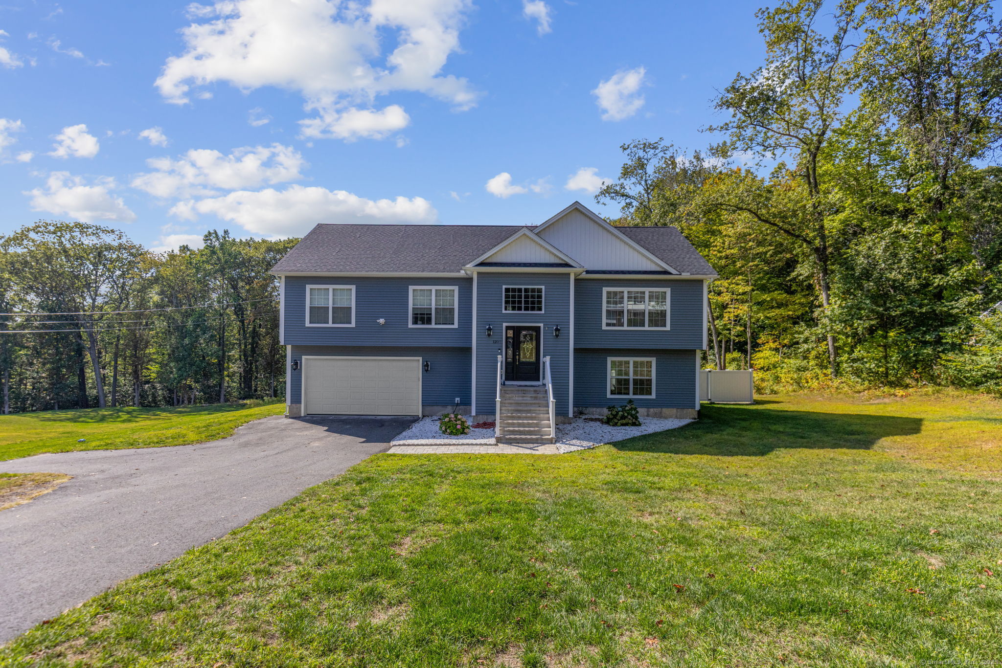 1209 Woodtick Road Wolcott, CT 06716 - Photo 2 of 40 a view of a house with a big yard and a large tree