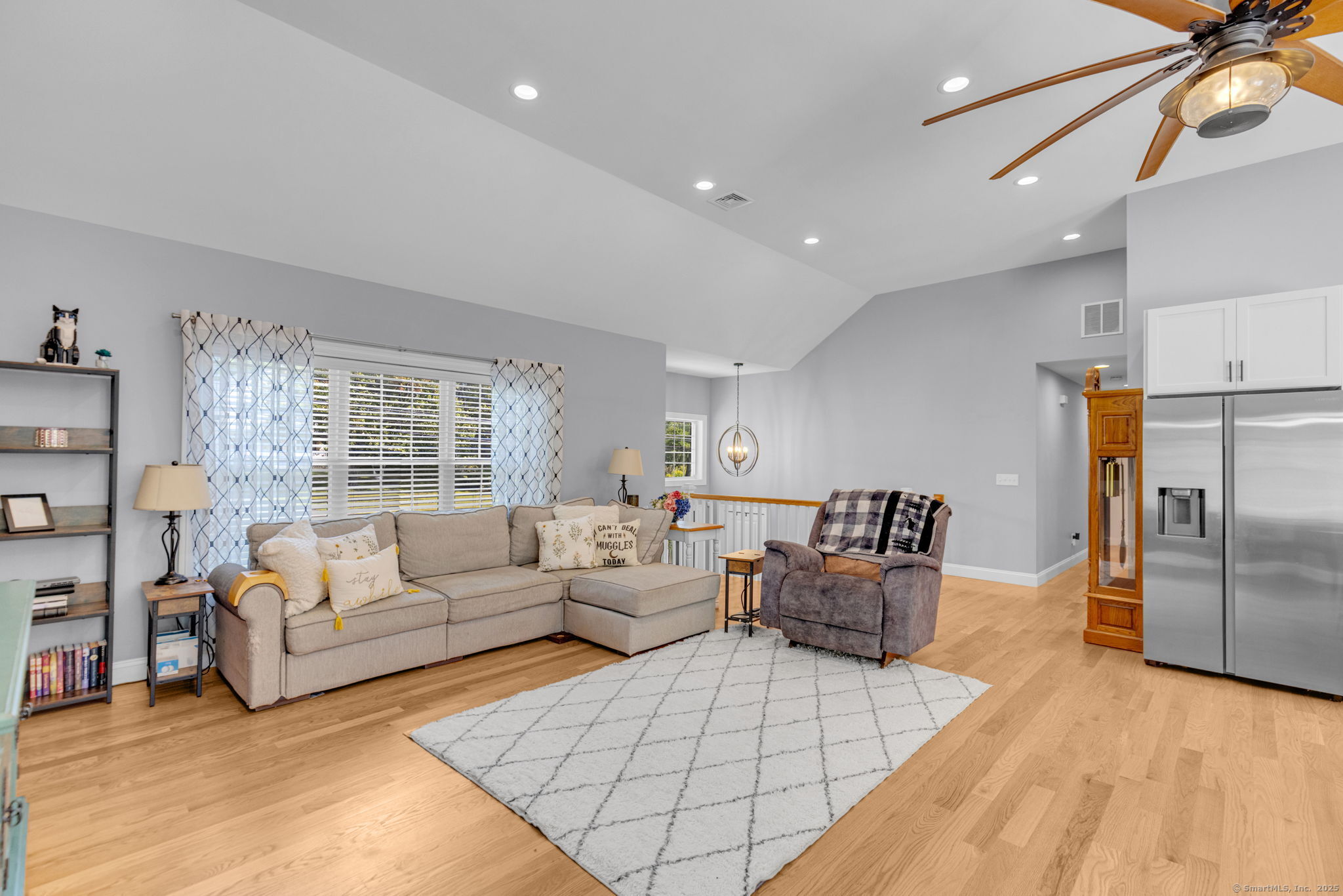 1209 Woodtick Road Wolcott, CT 06716 - Photo 3 of 40 a living room with furniture white walls and a chandelier
