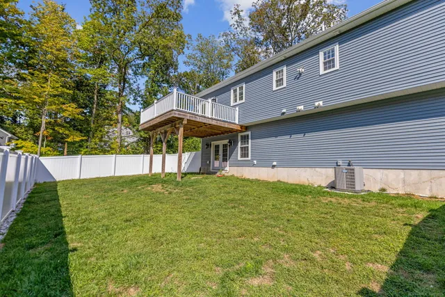 a backyard of a house with table and chairs