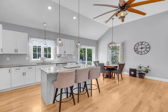 a kitchen with counter space dining table and chairs