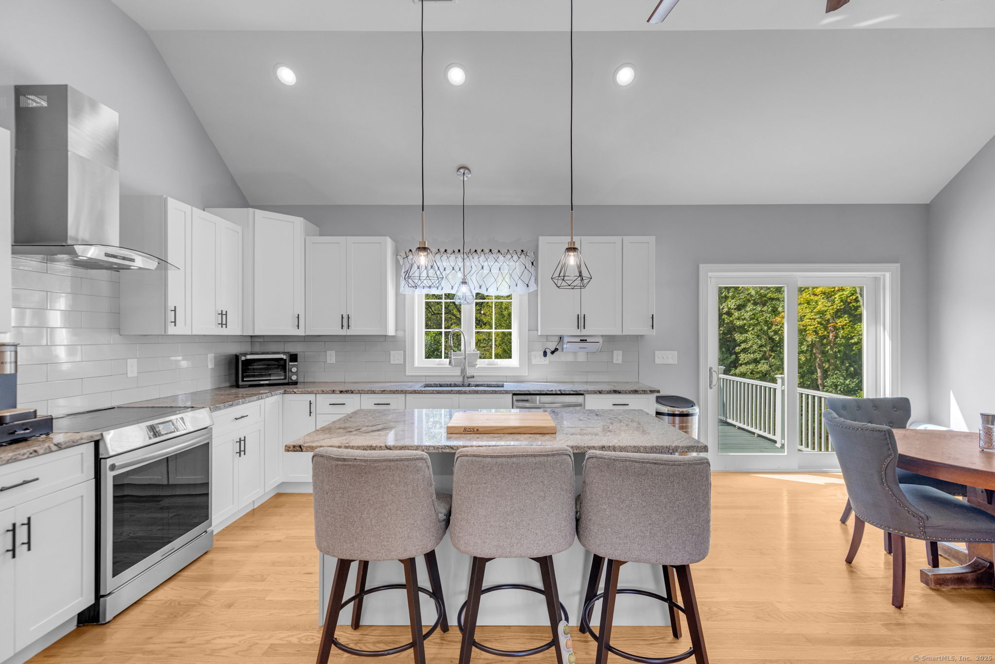 1209 Woodtick Road Wolcott, CT 06716 - Photo 9 of 40 a kitchen with stainless steel appliances granite countertop a stove a sink a microwave a center island and cabinets