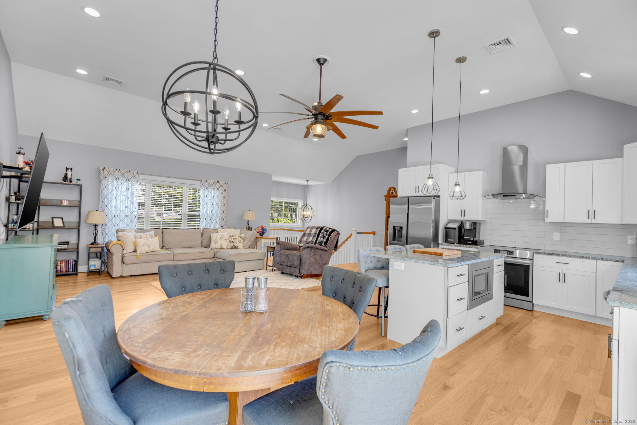 1209 Woodtick Road Wolcott, CT 06716 - Photo 10 of 40 a living room with kitchen island furniture and a chandelier