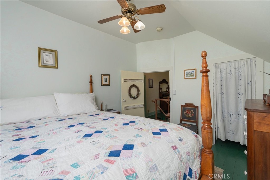2669 Triangle Road Mariposa, CA 95338 - Photo 16 of 58 a bedroom with a bed and a chandelier