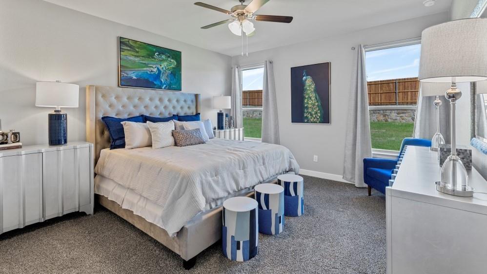 231 Windmill Drive Rhome, TX 76078 - Photo 13 of 30 a bedroom with a bed and a chandelier