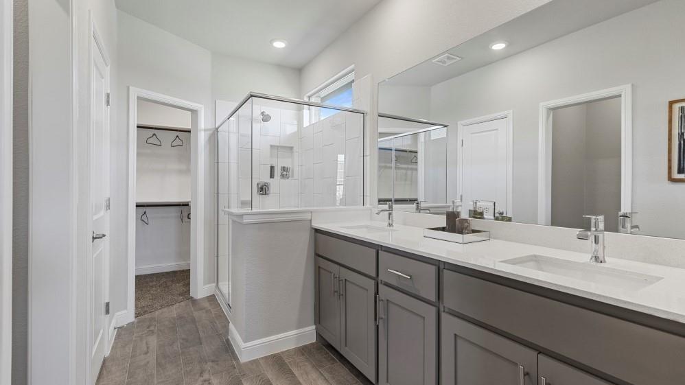 231 Windmill Drive Rhome, TX 76078 - Photo 16 of 30 a bathroom with a double vanity sink mirror and shower