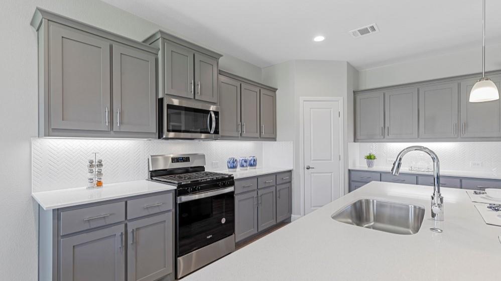 231 Windmill Drive Rhome, TX 76078 - Photo 3 of 30 a kitchen with kitchen island granite countertop a sink dishwasher stove top oven and cabinets