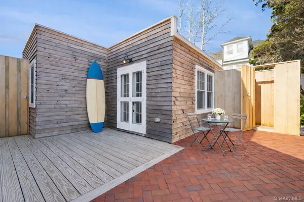 a view of a patio with wooden floor and seating space