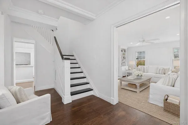 a living room with furniture and a potted plant