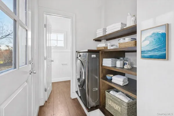 a view of a hallway with wooden floor and closet