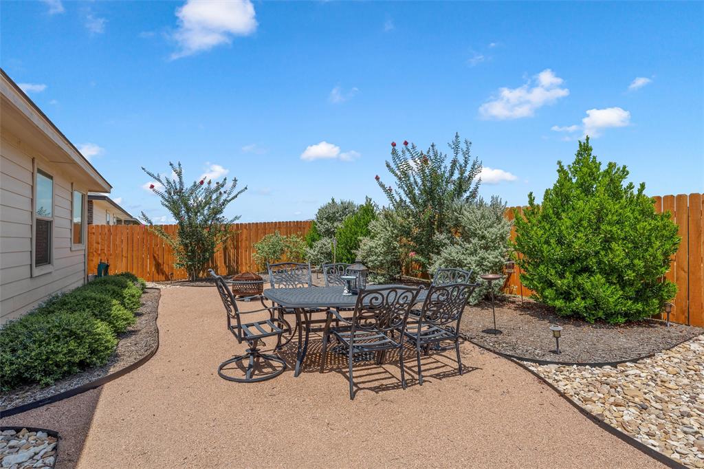 2912 Brosnan Road Lorena, TX 76655 - Photo 23 of 25 a view of a backyard with plants and a patio