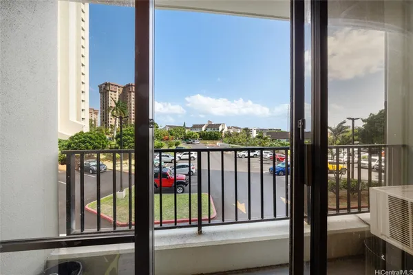 a view of a balcony with floor to ceiling windows and wooden floor