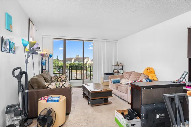 a living room with furniture a rug and a large window