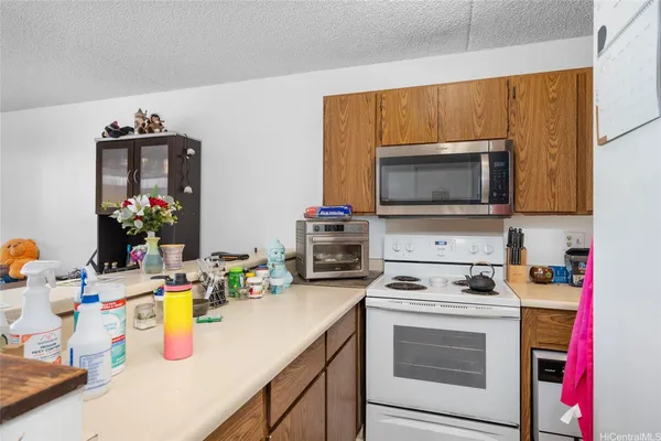 a kitchen with a sink stove and microwave