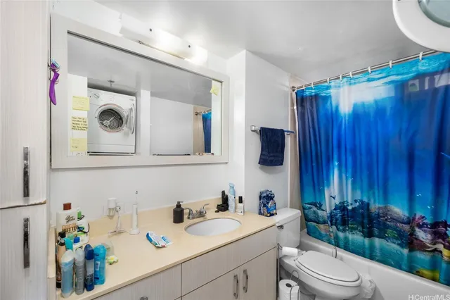 a bathroom with a sink vanity mirror and toilet
