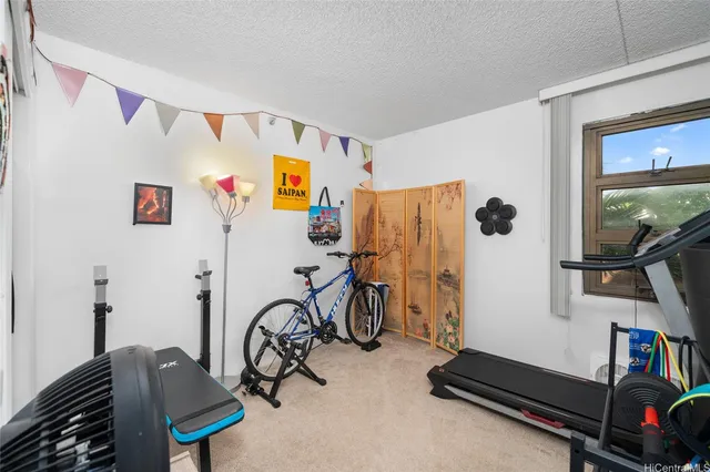 a room with gym equipment and a flat screen tv