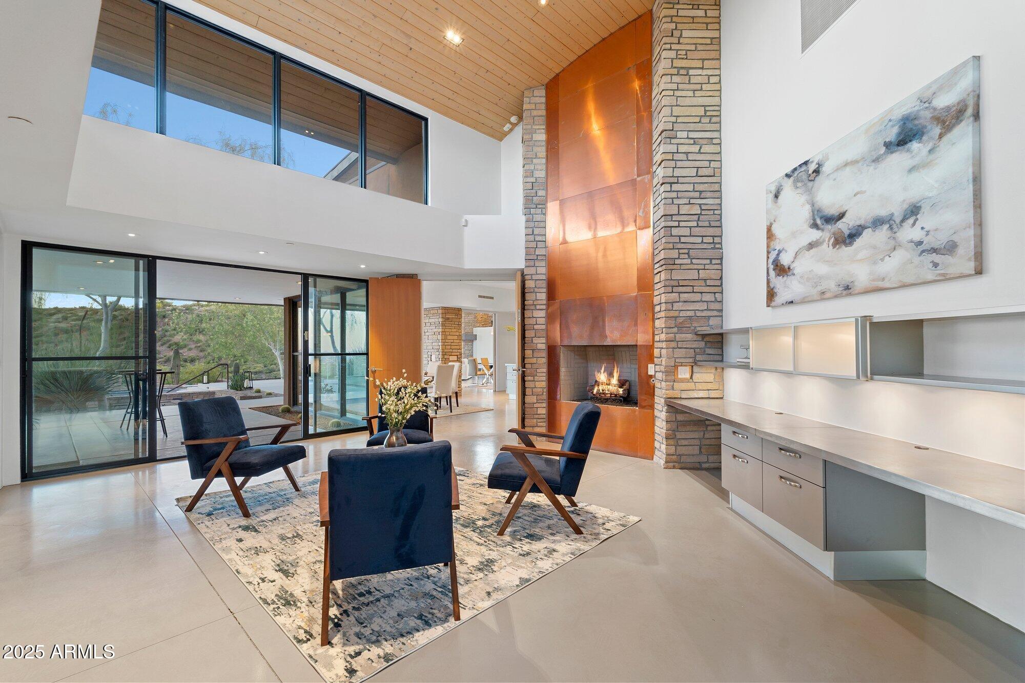 9626 East Aw Tillinghast Road Scottsdale, AZ 85262 - Photo 14 of 28 a view of a dining room with furniture a chandelier and wooden floor