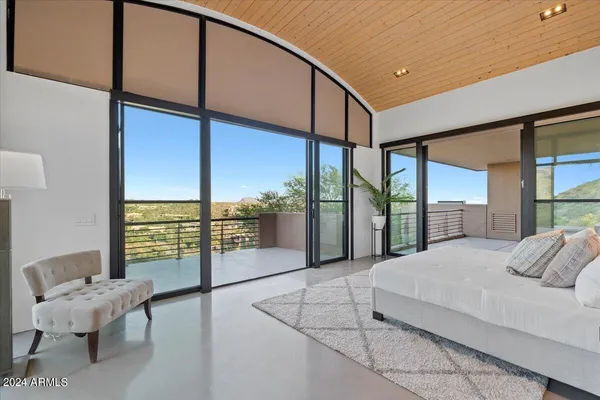 a bedroom with a large bed and a window