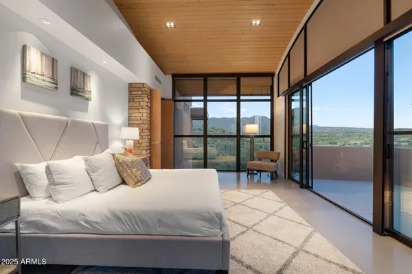 a bedroom with a large bed and a large window