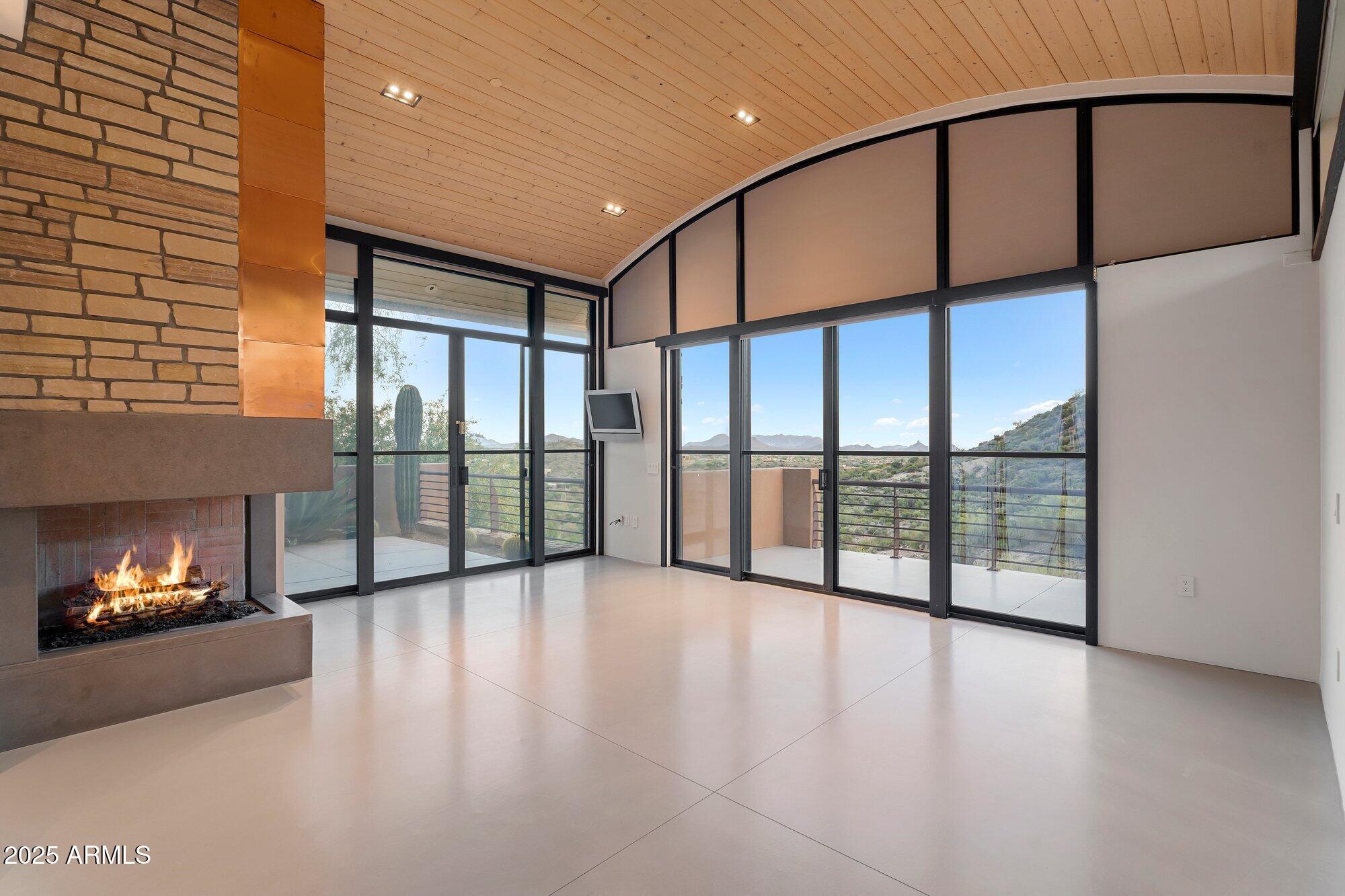 9626 East Aw Tillinghast Road Scottsdale, AZ 85262 - Photo 22 of 28 a view of an empty room window and a fireplace