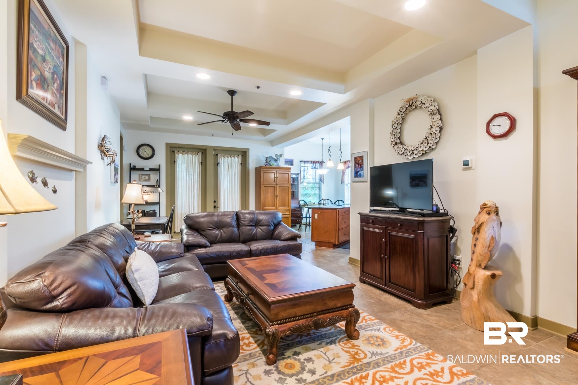 1430 Regency Road, Unit G103 Gulf Shores, AL 36542 - Photo 10 of 29 Tiled living room with french doors, ceiling fan, and a raised ceiling