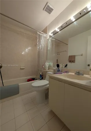a bathroom with a double vanity sink toilet and shower