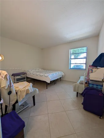 a bedroom with bed and window