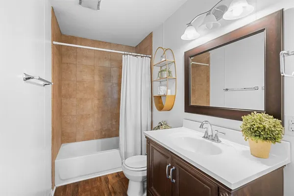 a bathroom with a sink toilet and shower