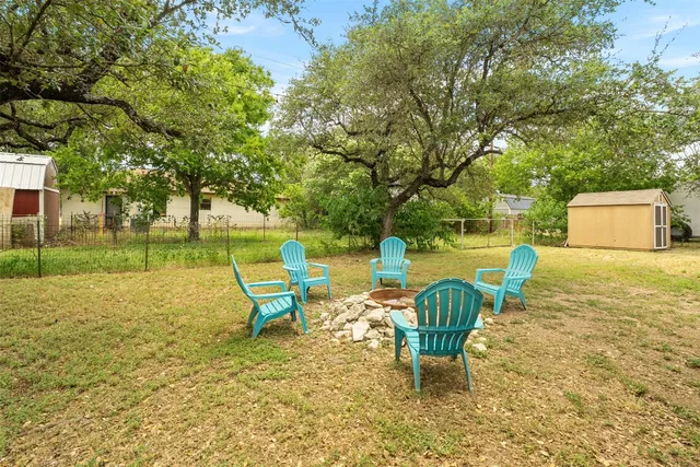 a chair and table sitting in backyard of house