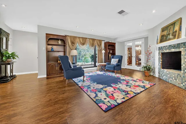 a living room with furniture fireplace and window