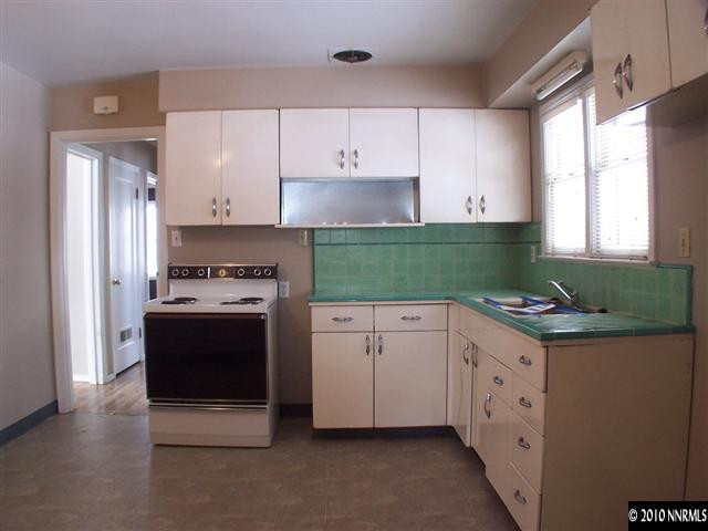 920 Bates Avenue Reno, NV 89502 - Photo 6 of 13 a kitchen with granite countertop a stove a sink and a refrigerator