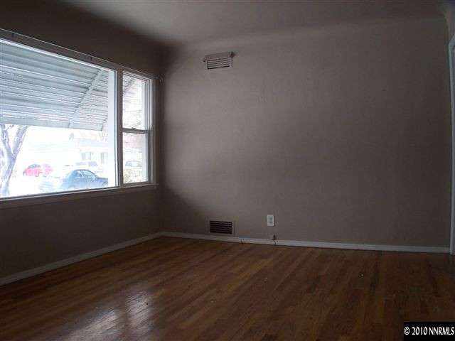 920 Bates Avenue Reno, NV 89502 - Photo 7 of 13 a view of an empty room with wooden floor and a window