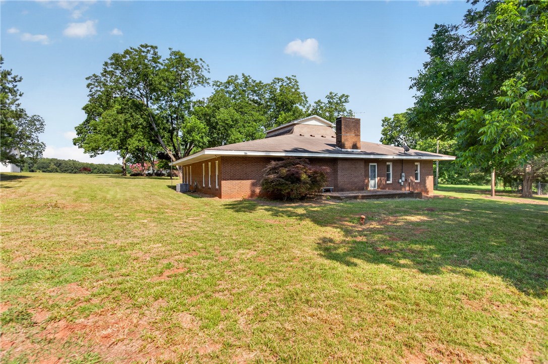 1412 Simpson Road Pendleton, SC 29670 - Photo 43 of 48 A classic brick exterior on this home offers a timeless aesthetic amidst a large, verdant lot.