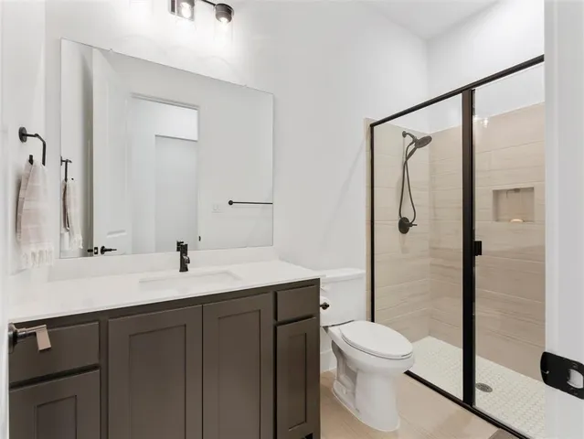 a bedroom with a bed and flat screen tv