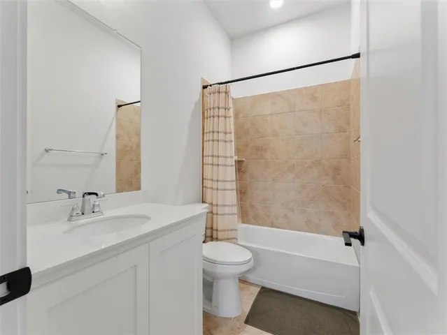 a work room with furniture a flat screen tv and a window