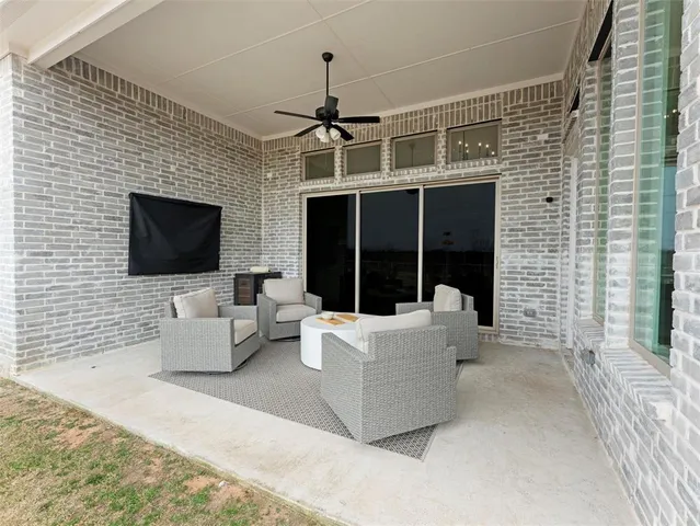 a view of a house with a small yard and wooden fence
