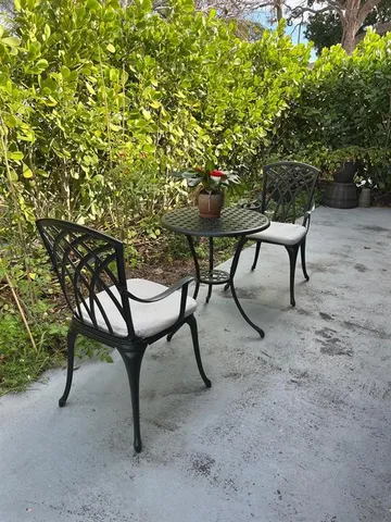 a backyard of a house with table and chairs
