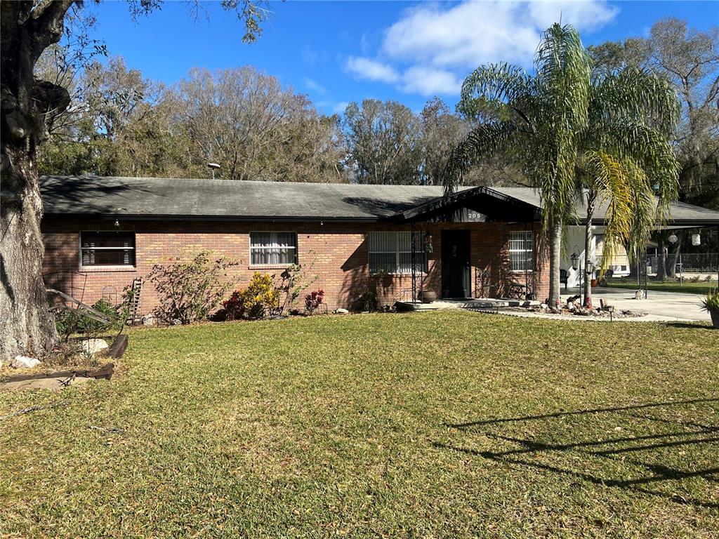 205 Fulton Green Road Lakeland, FL 33809 - Photo 1 of 1 a front view of a house with garden