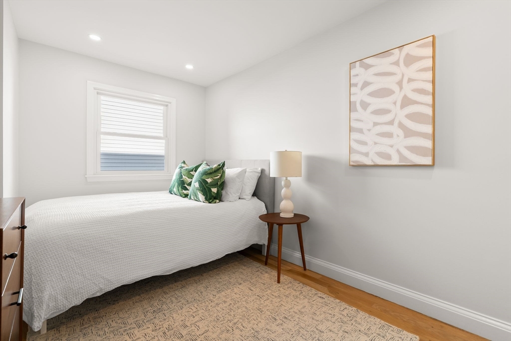 713-715 East 7th Street, Unit 715 Boston, MA 02127 - Photo 13 of 25 a bed sitting in a bedroom next to a window