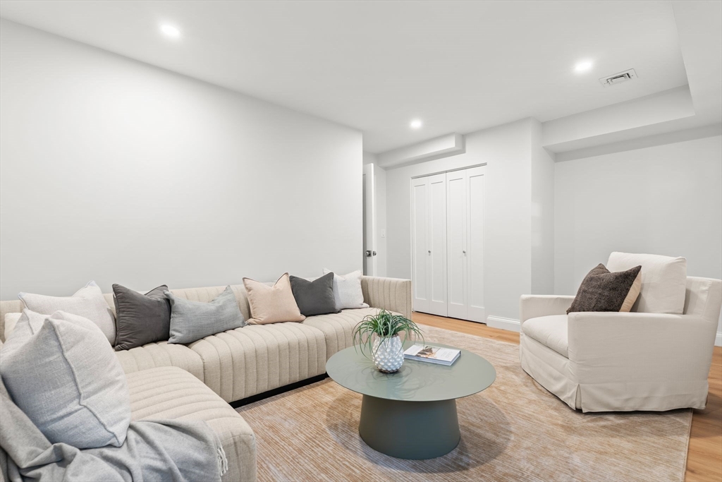 713-715 East 7th Street, Unit 715 Boston, MA 02127 - Photo 19 of 25 a living room with furniture and a wooden floor
