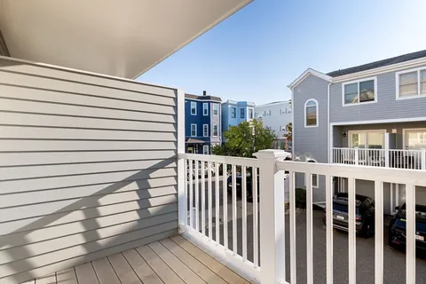 a view of a balcony with wooden floor and fence