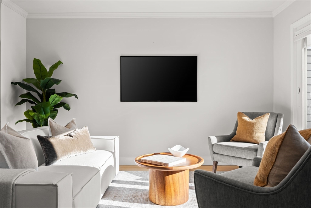 713-715 East 7th Street, Unit 715 Boston, MA 02127 - Photo 7 of 25 a living room with furniture and a flat screen tv