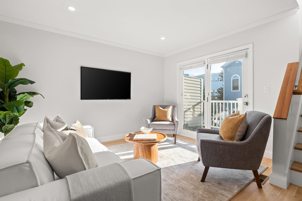 713-715 East 7th Street, Unit 715 Boston, MA 02127 - Photo 8 of 25 a living room with furniture and a flat screen tv