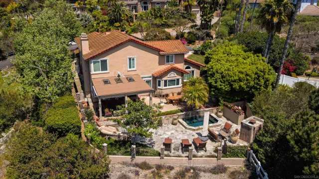 an aerial view of a house with a yard and potted plants